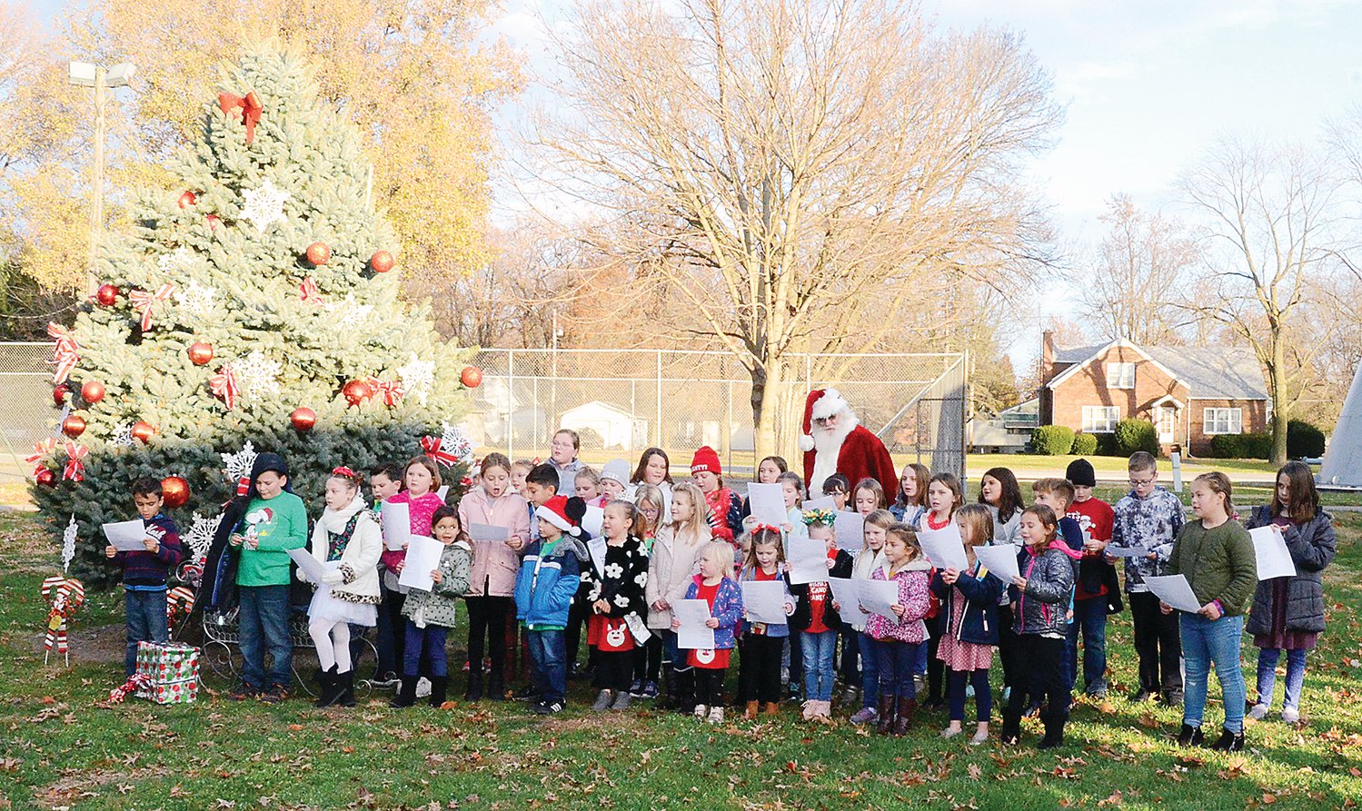Under the direction of teacher Sarah Weatherford, elementary students in the Panhandle School District, along with a little help from Santa, sang several holiday songs just before the annual tree lighting ceremony in downtown Farmersville on Saturday, Nov. 27.